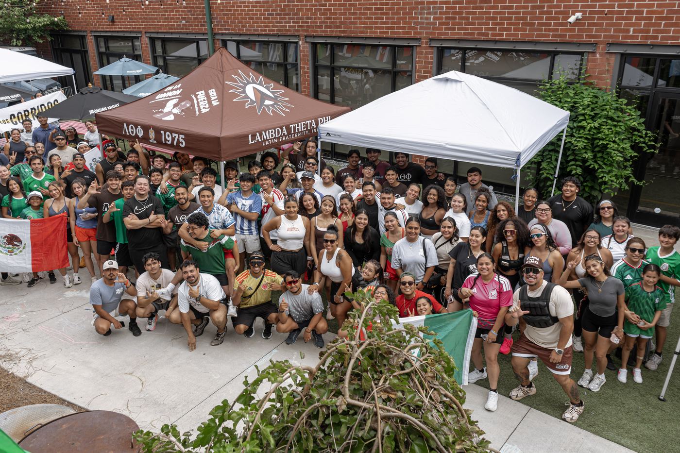 The whole group gathered under the Lambda Theta Phi tent for the group photograph.